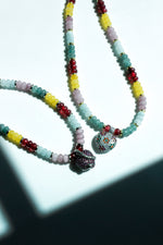 Beaded necklace with green jade, aquamarine, rose quartz, cherry jade, and yellow jade, featuring a multicolor crystal-encrusted sterling silver heart pendant